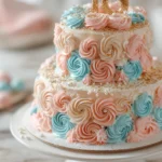 Close-up of a three-tier pastel pink and blue birthday cake with smooth vanilla buttercream frosting, piped rosettes, fondant numbers '18', and edible gold glitter on a white cake stand