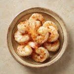 Close-up of air fryer frozen jumbo butterfly shrimp with crispy golden texture