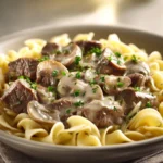 Close-up of Beef Stroganoff with creamy sauce and tender beef slices on a clean plate