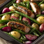 Close-up of a green bean sausage sheet pan dinner with vibrant colors and textures