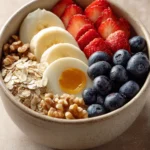 Close-up of a healthy breakfast meal prep with fresh fruits and grains.