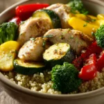 Close-up of a high-protein meal with grilled chicken, vegetables, and grains on a clean plate.