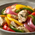 Close-up of Instant Pot chicken and peppers with bright colors and clean presentation.