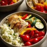 Close-up of a low carb dinner prep with vibrant vegetables and grilled chicken