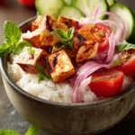 Close-up of a Middle Eastern Tofu Rice Bowl with vibrant vegetables and herbs