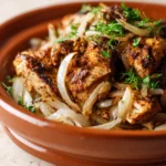 Close-up of slow cooker chicken shawarma with bright, warm lighting and clean background.