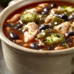 Close-up of slow cooker chili relleno soup with vibrant ingredients and creamy texture.