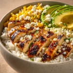 Close-up of a Street Corn Chicken Bowl with vibrant toppings and creamy sauce.