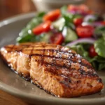 Close-up of Texas Roadhouse grilled salmon with a clean background and warm lighting.