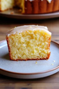 Close-up of a lemon cake slice with a clean background, showcasing its texture and color.