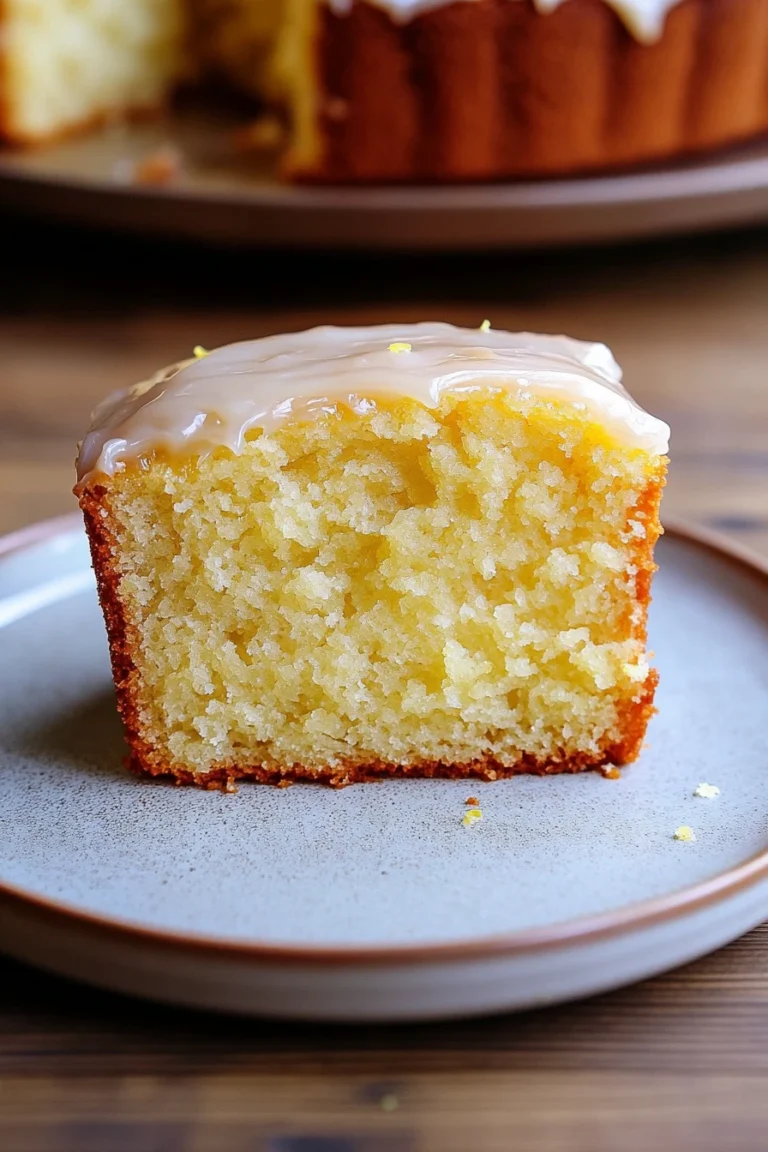 Close-up of a lemon cake slice with a clean background, showcasing its texture and color.